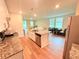 Open-concept kitchen with an island that includes a dishwasher and a dual sink at 877 Rivers Crossings St, Clermont, FL 34714