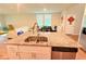 Granite countertop kitchen island with dual sinks and stainless steel dishwasher at 877 Rivers Crossings St, Clermont, FL 34714