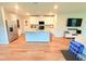 Open-concept kitchen featuring a large island, granite countertops, and stainless steel appliances at 877 Rivers Crossings St, Clermont, FL 34714