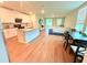 Open-concept kitchen featuring a large island, granite countertops, and white cabinets at 877 Rivers Crossings St, Clermont, FL 34714
