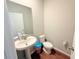 Powder room featuring tile floors, a pedestal sink and standard toilet at 877 Rivers Crossings St, Clermont, FL 34714