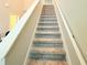 Carpeted stairway with white railing at 877 Rivers Crossings St, Clermont, FL 34714