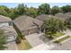 Aerial view of the home featuring a three-car garage and well-manicured landscaping at 886 Sherbourne Cir, Lake Mary, FL 32746