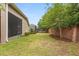 Green backyard with a brick wall and partial view of the pool at 886 Sherbourne Cir, Lake Mary, FL 32746