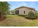 Well-maintained backyard with privacy hedges and partial view of screened enclosure at 886 Sherbourne Cir, Lake Mary, FL 32746