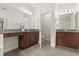Bright bathroom with double vanity, granite countertops, and wood-look tile flooring at 886 Sherbourne Cir, Lake Mary, FL 32746