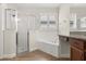 Bathroom featuring a glass shower, soaking tub and beautiful vanity at 886 Sherbourne Cir, Lake Mary, FL 32746