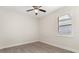 Bright bedroom with neutral walls, wood-look tile floors, and a window with blinds at 886 Sherbourne Cir, Lake Mary, FL 32746
