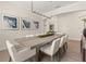 Bright dining room with a long table, modern chandelier, and artwork, creating an elegant space for gatherings at 886 Sherbourne Cir, Lake Mary, FL 32746