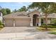 Inviting single-story home featuring a three-car garage and a well-maintained front yard with mature trees at 886 Sherbourne Cir, Lake Mary, FL 32746
