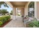 Inviting covered front porch with comfortable seating, lush landscaping, and views of the neighborhood at 886 Sherbourne Cir, Lake Mary, FL 32746
