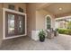 Welcoming covered front porch with double doors and cozy seating area, perfect for relaxing outdoors at 886 Sherbourne Cir, Lake Mary, FL 32746