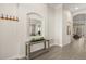 Stylish hallway with decorative console table and mirror, creating an elegant and welcoming entrance at 886 Sherbourne Cir, Lake Mary, FL 32746