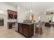 Kitchen island with seating and view into the living room at 886 Sherbourne Cir, Lake Mary, FL 32746