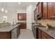 Kitchen with granite countertops, tile backsplash, and stainless steel appliances at 886 Sherbourne Cir, Lake Mary, FL 32746