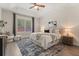 Primary bedroom features tray ceilings, large windows, and neutral decor at 886 Sherbourne Cir, Lake Mary, FL 32746