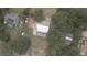 An aerial view showcasing the property and its surroundings with a pool at 949 Shadow Oaks Rd, Kissimmee, FL 34744