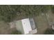 Aerial view of this home showcasing the pool and surrounding lush trees at 949 Shadow Oaks Rd, Kissimmee, FL 34744