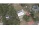 Aerial view of a home with a pool, backyard and surrounding trees at 949 Shadow Oaks Rd, Kissimmee, FL 34744