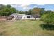 Expansive backyard features a home with a screened pool and ample green space at 949 Shadow Oaks Rd, Kissimmee, FL 34744