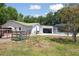 View of a house with an enclosed pool and large yard at 949 Shadow Oaks Rd, Kissimmee, FL 34744