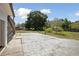 Spacious backyard featuring a stone patio, offering ample space for outdoor activities and relaxation at 949 Shadow Oaks Rd, Kissimmee, FL 34744