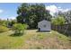 View of backyard featuring a storage shed, providing ample space for tools and outdoor equipment at 949 Shadow Oaks Rd, Kissimmee, FL 34744