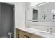 Bright bathroom offers double sinks, modern vanity, sleek mirrors and a glass shower at 949 Shadow Oaks Rd, Kissimmee, FL 34744