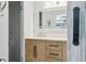 Bathroom featuring a modern vanity, quartz countertop, custom drawers, mirror and barn door at 949 Shadow Oaks Rd, Kissimmee, FL 34744