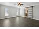 Bright bedroom features sleek floors, a ceiling fan, and a sliding barn door to the bathroom at 949 Shadow Oaks Rd, Kissimmee, FL 34744