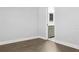 Empty bedroom with wooden floors has an entry into an updated bathroom at 949 Shadow Oaks Rd, Kissimmee, FL 34744