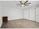 Bright bedroom with hardwood floors, closet, and ceiling fan at 949 Shadow Oaks Rd, Kissimmee, FL 34744