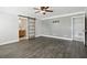 Bright bedroom features sleek floors, ceiling fan, and a sliding barn door to the bathroom at 949 Shadow Oaks Rd, Kissimmee, FL 34744