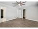 Spacious bedroom featuring a ceiling fan, hardwood floors, and a walk-in closet at 949 Shadow Oaks Rd, Kissimmee, FL 34744