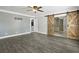 Bedroom featuring ceiling fan, grey walls, wood flooring and sliding barn door to closet area at 949 Shadow Oaks Rd, Kissimmee, FL 34744