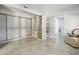 Bright walk-in closet with custom shelving, drawers, light-colored tile floors and a decorative chair at 949 Shadow Oaks Rd, Kissimmee, FL 34744