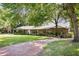 A spacious one-story brick home with a long driveway and lush landscaping at 949 Shadow Oaks Rd, Kissimmee, FL 34744