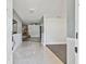 Inviting foyer showcasing pristine tile floors, leading to a living room with a brick fireplace and barn door at 949 Shadow Oaks Rd, Kissimmee, FL 34744