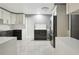 Modern kitchen featuring white and grey cabinetry, stainless steel appliances, and a spacious layout at 949 Shadow Oaks Rd, Kissimmee, FL 34744