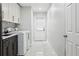 Bright laundry room has updated cabinets, tile floors, and a windowed door to the outside at 949 Shadow Oaks Rd, Kissimmee, FL 34744