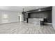 Open living room with neutral walls, a mosaic bar, and lots of natural light at 949 Shadow Oaks Rd, Kissimmee, FL 34744