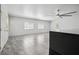 Open living room with tile floors, large windows, and neutral decor at 949 Shadow Oaks Rd, Kissimmee, FL 34744