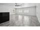 Bright living room features neutral walls, modern fan, and sleek tile flooring at 949 Shadow Oaks Rd, Kissimmee, FL 34744
