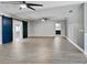 Spacious living room features modern ceiling fan, beautiful grey flooring, and sliding barn door at 949 Shadow Oaks Rd, Kissimmee, FL 34744
