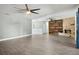 Expansive living room featuring a brick fireplace and grey flooring at 949 Shadow Oaks Rd, Kissimmee, FL 34744