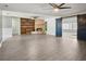 Expansive living room showcasing a brick fireplace, built-in shelving, and barn door, perfect for entertaining at 949 Shadow Oaks Rd, Kissimmee, FL 34744
