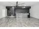 Open living room with neutral walls, a mosaic bar, and lots of natural light at 949 Shadow Oaks Rd, Kissimmee, FL 34744