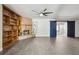 Open living area featuring a brick fireplace, shelving, and barn door, creating a cozy yet stylish ambiance at 949 Shadow Oaks Rd, Kissimmee, FL 34744