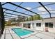 Beautiful backyard oasis features a screened pool, ideal for swimming and outdoor enjoyment at 949 Shadow Oaks Rd, Kissimmee, FL 34744