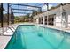 Stunning screened pool area with clear blue water, perfect for swimming and relaxation at 949 Shadow Oaks Rd, Kissimmee, FL 34744